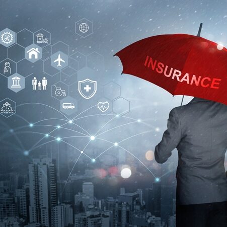 Insurance concept, Businessman holding red umbrella on falling rain with protect with icon business, health, financial, life, family, accident and logistics insurance on city background